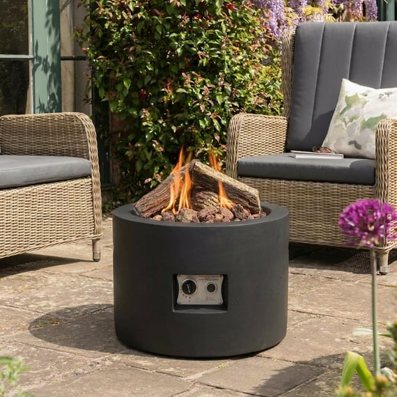 Happy Cocoon 61cm round black steel fire pit bowl on a UK garden patio